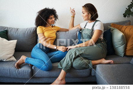 Conversation, lesbian with couple and relax on sofa in the living room talking, gossip and bonding. Happy, love and young interracial lgbtq women speaking and resting together in lounge at home Conversation, lesbian with couple and relax on sofa in the living room talking, gossip and bonding. Happy, love and young interracial lgbtq women speaking and resting together in lounge at home 138188558