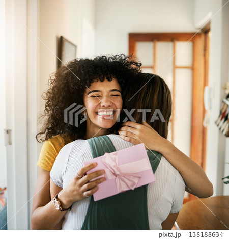 Excited, happy hug and present for birthday of girl friends and smile from kindness. Surprise, gift and female person at home with giving in lounge with celebration, congratulations and package Excited, happy hug and present for birthday of girl friends and smile from kindness. Surprise, gift and female person at home with giving in lounge with celebration, congratulations and package 138188634