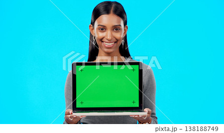 Portrait, woman and green screen space on laptop for advertising, sign up offer and info in studio. Happy indian model, computer and tracking markers for newsletter, review or deal on blue background Portrait, woman and green screen space on laptop for advertising, sign up offer and info in studio. Happy indian model, computer and tracking markers for newsletter, review or deal on blue background 138188749