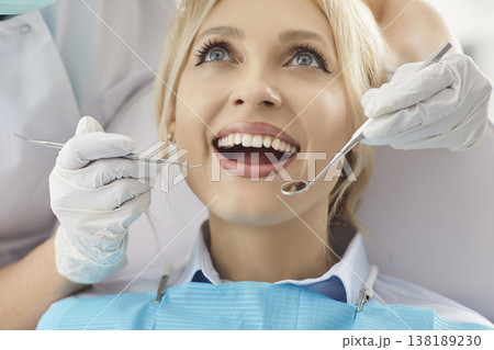Close up shot of young woman keeping mouth widely opened, going to cure teeth in dentistry clinic 138189230