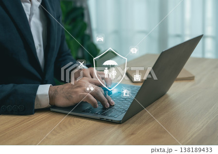 Businessman using laptop with insurance icons representing coverage, protection, family and security for modern digital service concepts. 138189433