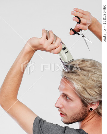 Man going to shave his long hair Man going to shave his long hair 138189460