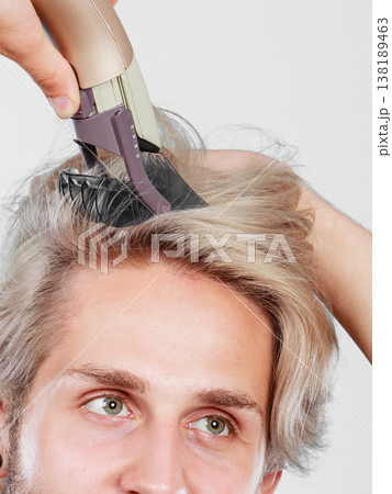 Man going to shave his long hair Man going to shave his long hair 138189463