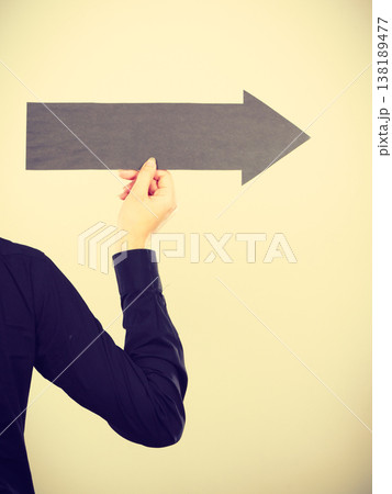 Man holding black arrow pointing right Man holding black arrow pointing right 138189477