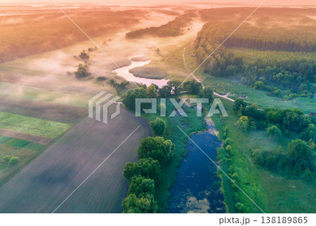 Magic sunrise over the lake. Misty early morning, rural landscape, wilderness, mystical feeling. Serenity lake in magical light Magic sunrise over the lake. Misty early morning, rural landscape, wilderness, mystical feeling. Serenity lake in magical light 138189865