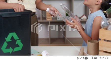 Child and parent recycling plastic bottles at home Child and parent recycling plastic bottles at home 138190474
