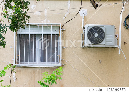 Multiple outdoor air conditioning units installed on exterior wall of residential building. Urban cooling systems and climate control concept. 138190873