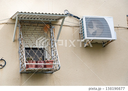Multiple outdoor air conditioning units installed on exterior wall of residential building. Urban cooling systems and climate control concept. Multiple outdoor air conditioning units installed on exterior wall of residential building. Urban cooling systems and climate control concept. 138190877
