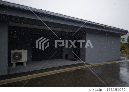 Modular modern smart automated house garage exterior in winter snow with insulation and ongoing work Modular modern smart automated house garage exterior in winter snow with insulation and ongoing work 138191051