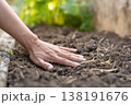 土壌の健康を確かめるように土に優しく触れる農作業の手元 138191676