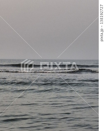 Calm Ocean Waves Under a Soft Purple and Gray Sky at Twilight Calm Ocean Waves Under a Soft Purple and Gray Sky at Twilight 138192727