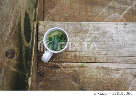 Cup Of Fresh Herbal Tea On Wooden Steps Cup Of Fresh Herbal Tea On Wooden Steps 138193360