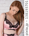 Beautiful redhead model in pink and black lace lingerie, posing on her bed in an old house 138193701