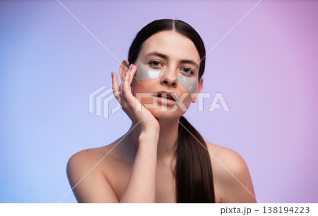 Young woman applying under-eye patches for skincare and anti-aging treatment, focusing on beauty, self-care, and achieving healthy, glowing skin Young woman applying under-eye patches for skincare and anti-aging treatment, focusing on beauty, self-care, and achieving healthy, glowing skin 138194223