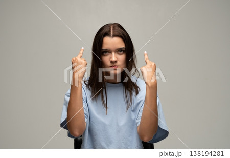 Young woman showing middle finger, expressing frustration, anger, and disrespect with rude hand gesture 138194281
