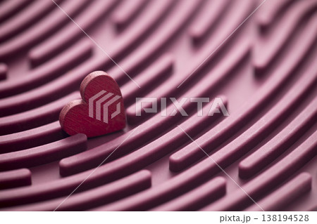 Red heart in round labyrinth. Love search concept 138194528