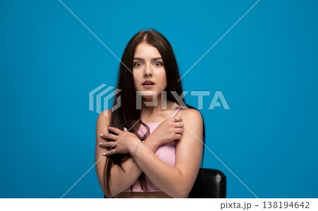 Young woman feeling surprised and shocked, expressing fear and anxiety with wide eyes, looking frightened on blue background Young woman feeling surprised and shocked, expressing fear and anxiety with wide eyes, looking frightened on blue background 138194642