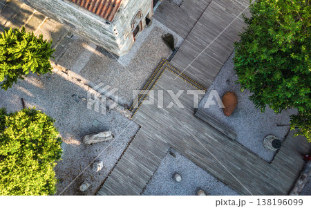 An aerial, top-down view of a courtyard featuring a weathered st An aerial, top-down view of a courtyard featuring a weathered st 138196099