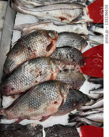 Fresh fish are displayed on ice at a market in the evening for customers Fresh fish are displayed on ice at a market in the evening for customers 138196638