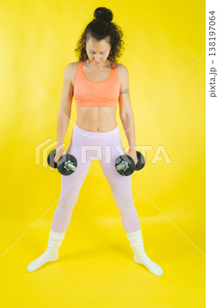 Woman exercising with dumbbells doing fitness workout Woman exercising with dumbbells doing fitness workout 138197064