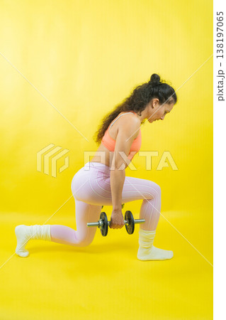 Woman exercising doing lunges holding dumbbell workout 138197065