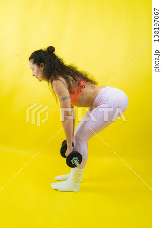 Woman exercising with dumbbells for fitness and workout Woman exercising with dumbbells for fitness and workout 138197067
