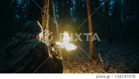 Red army soviet russian soldier soldier firing machine gun with large muzzle flash in night battle Red army soviet russian soldier soldier firing machine gun with large muzzle flash in night battle 138197076