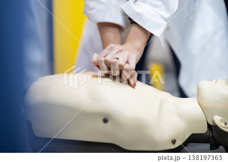 Student hands performing cpr on medical training dummy 138197363