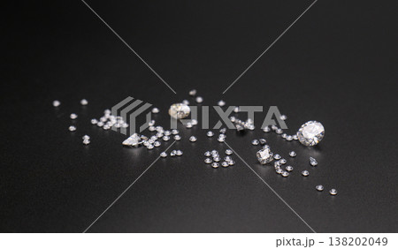 Dark background highlights sparkling gemstones of various sizes Dark background highlights sparkling gemstones of various sizes 138202049