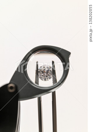 Close-up of diamond being examined with magnifying tool Close-up of diamond being examined with magnifying tool 138202055