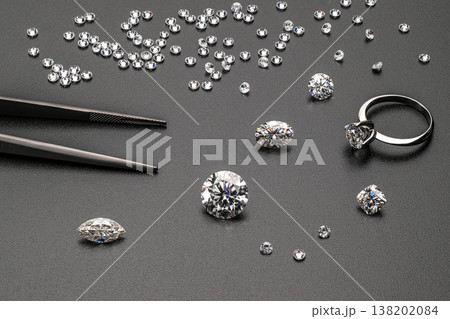 Close-up of loose diamonds and tools for setting Close-up of loose diamonds and tools for setting 138202084