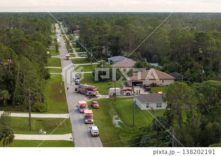 First responders arrived at fire alarm call ready to extinguish fire of burning house. Emergency service personnel responding to potential fire hazard at Florida home 138202191