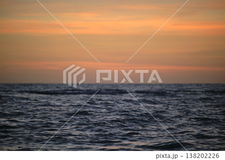 Dramatic red ocean waves at sunset with soft evening sea dark water Dramatic red ocean waves at sunset with soft evening sea dark water 138202226