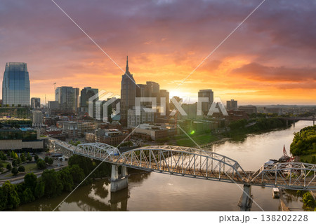 Downtown district of Nashville city in Tennessee, USA. Modern metropolitan area with riverfront, bridge and sunset horizon. Downtown district of Nashville city in Tennessee, USA. Modern metropolitan area with riverfront, bridge and sunset horizon. 138202228