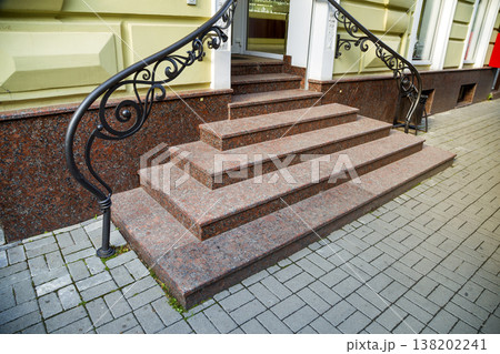 Detail of a house facade. New granite stairs with metal railings. Detail of a house facade. New granite stairs with metal railings. 138202241
