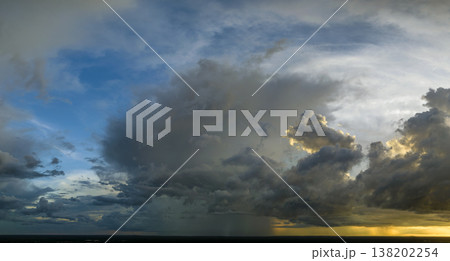 Cumulonimbus clouds forming before thunderstorm on evening sky. Changing stormy cloudscape weather at sunset Cumulonimbus clouds forming before thunderstorm on evening sky. Changing stormy cloudscape weather at sunset 138202254