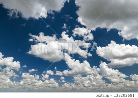 Bright landscape of blue sky with flying white clouds. Colorful summer skyscape Bright landscape of blue sky with flying white clouds. Colorful summer skyscape 138202681