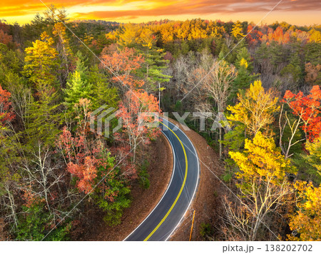 Blue Ridge Parkway in autumn. Mountain pass road between dense woods in seasonal colors in North Carolina Blue Ridge Parkway in autumn. Mountain pass road between dense woods in seasonal colors in North Carolina 138202702