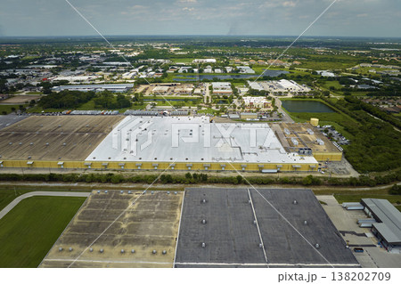 Big corporate shipment center with many cargo semi trucks unloading and uploading retail products for further retail shipment. Global market concept 138202709