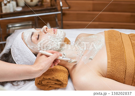 Young Caucasian Female Receiving Facial Mask Treatment At Spa For Relaxation And Rejuvenation Young Caucasian Female Receiving Facial Mask Treatment At Spa For Relaxation And Rejuvenation 138202837