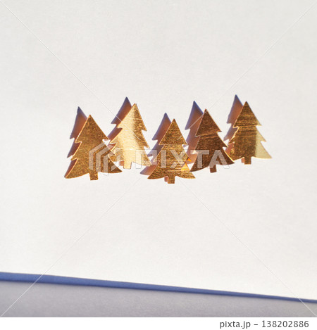 Golden Christmas Trees Cutouts On White Paper Casting Shadows Under Sunlight Golden Christmas Trees Cutouts On White Paper Casting Shadows Under Sunlight 138202886