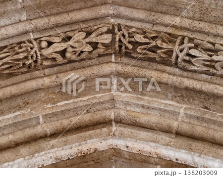 Image of aged arch, Photograph depicting old limestone arch with elaborate foliage engravings and textures Image of aged arch, Photograph depicting old limestone arch with elaborate foliage engravings and textures 138203009