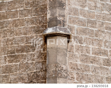 Weathered corner with textured stones, Rough stone corner featuring organic staining and mortar joints 138203018