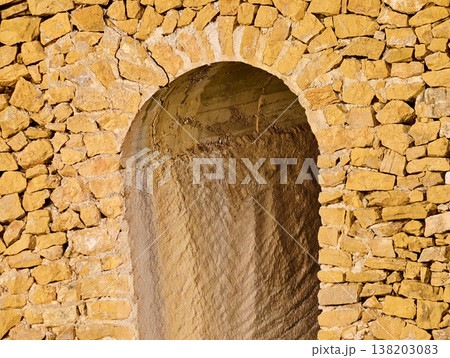 Heritage architectural marvel featuring sunlit sandstone arch and intricate craftsmanship details Heritage architectural marvel featuring sunlit sandstone arch and intricate craftsmanship details 138203083