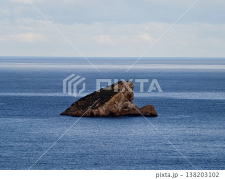 Quiet Coastal Rock Formation, Isolated Stony Peak Over Serene Ocean Surface with Tranquil Reflection Quiet Coastal Rock Formation, Isolated Stony Peak Over Serene Ocean Surface with Tranquil Reflection 138203102