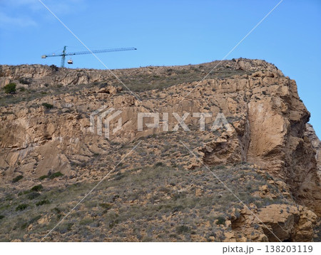 Trail by cliffs, Journey along craggy ridge with coastal scenery and stone steps during golden light 138203119