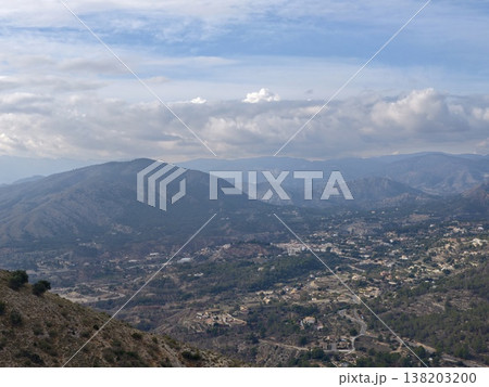 Scenic mountain village, Rustic village nestled beneath towering mountain ranges and lush greenery 138203200