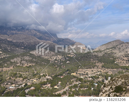 Serene countryside with cultivated plots, Tranquil village surrounded by farming and orchards 138203206