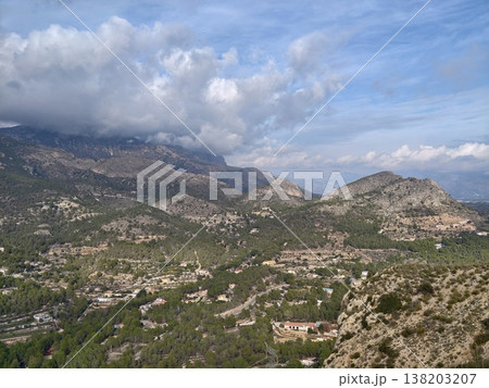 Sunlit hills and lush greenery for relaxation, Dramatic sky over rolling meadows and vibrant plant life 138203207