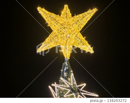 Seasonal celebration rooftop decoration, Bright golden ornament highlights joyful public seasonal event 138203272